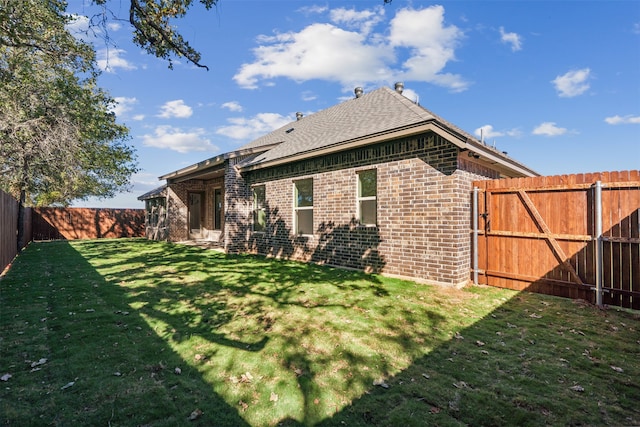 rear view of property featuring a yard