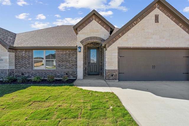 view of front of property featuring a garage and a front lawn