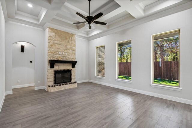 unfurnished living room featuring hardwood / wood-style flooring, ornamental molding, a fireplace, and coffered ceiling