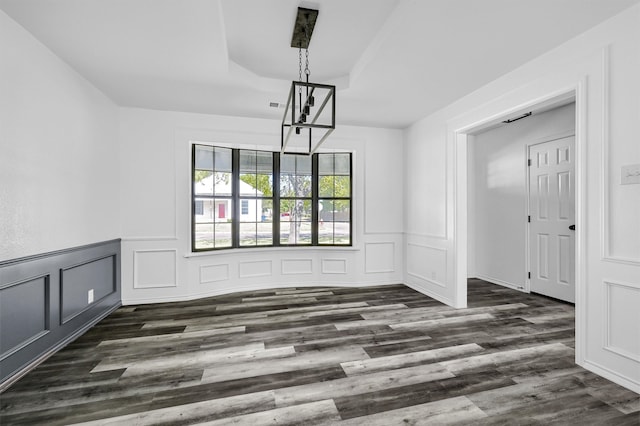 unfurnished dining area featuring dark wood-type flooring