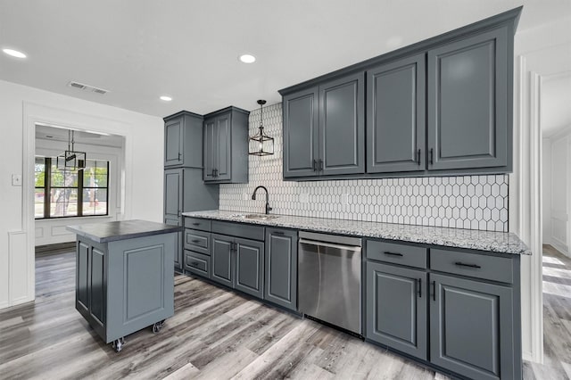 608 N Ave, Whitesboro, TX 76273 - kitchen featuring stainless steel dishwasher, light wood finished floors, a sink, backsplash, and a center island