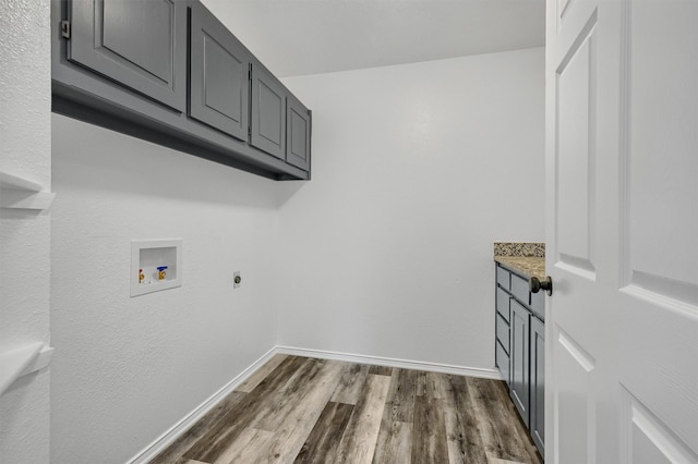 laundry room with hookup for a washing machine, cabinets, dark hardwood / wood-style flooring, and hookup for an electric dryer