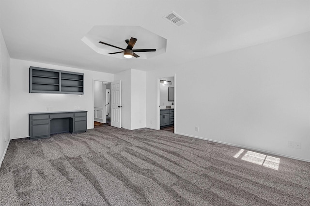608 N Ave, Whitesboro, TX 76273 - unfurnished living room with a ceiling fan, carpet, baseboards, a desk, and a tray ceiling