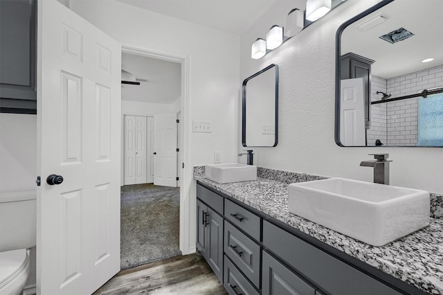 608 N Ave, Whitesboro, TX 76273 - full bath with toilet, double vanity, wood finished floors, and a tile shower