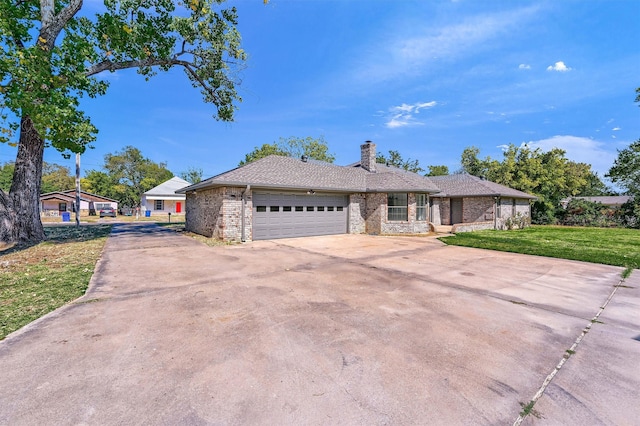 single story home featuring a garage and a front lawn