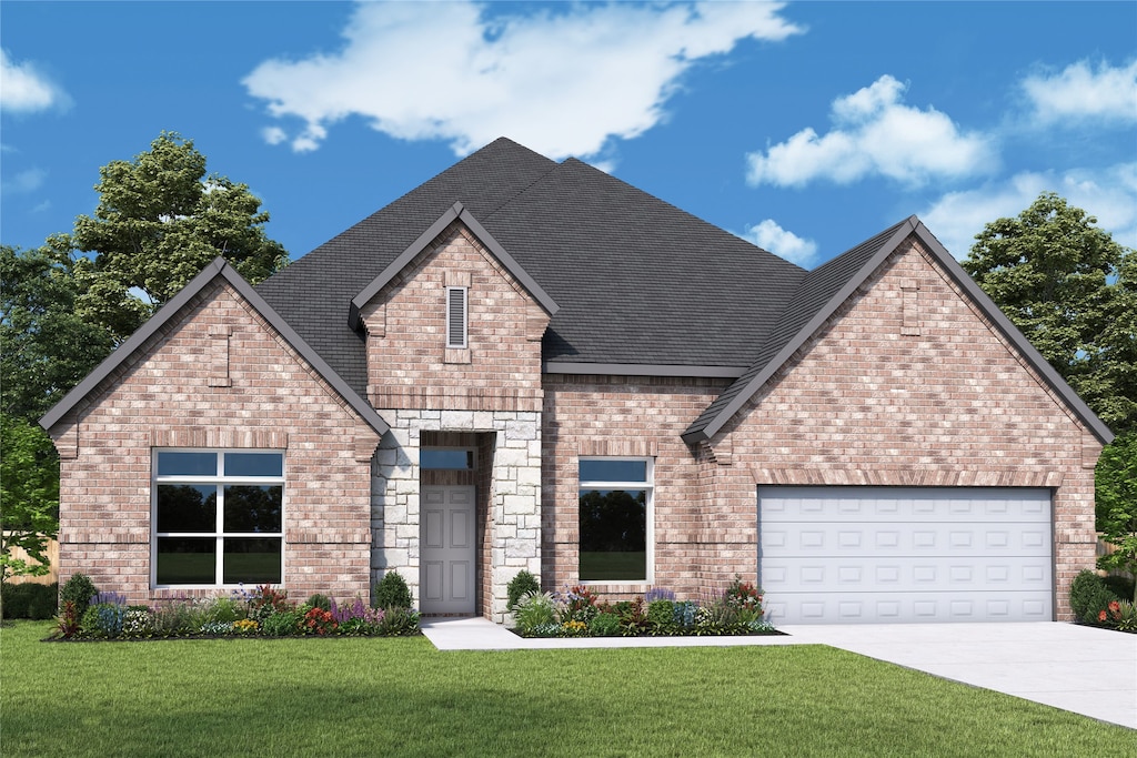 view of front of property with a front lawn and a garage