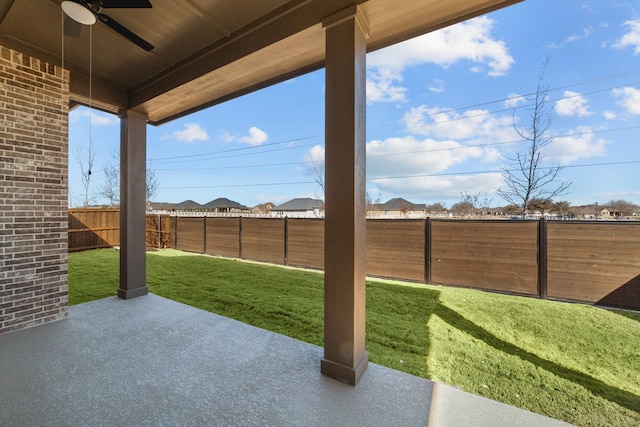 view of yard with a fenced backyard, a patio, and ceiling fan