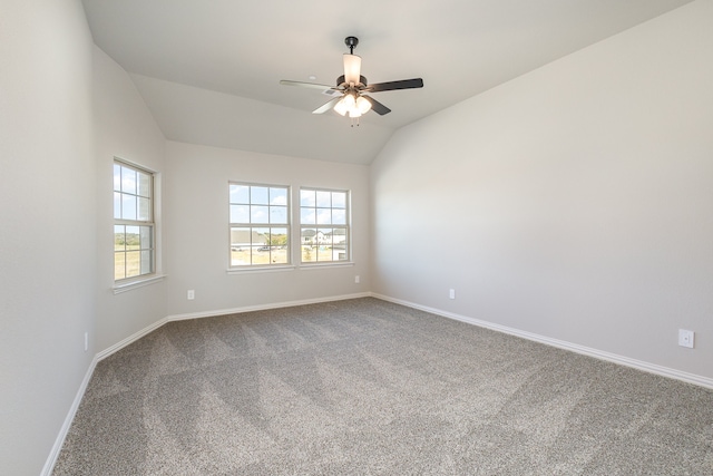 spare room featuring ceiling fan, lofted ceiling, and carpet floors