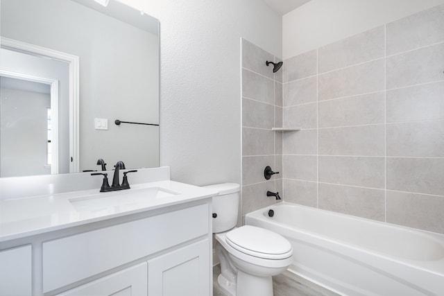 full bathroom with vanity, toilet, tiled shower / bath combo, and wood-type flooring