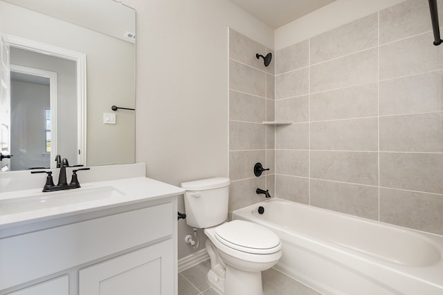 full bathroom featuring vanity, tiled shower / bath, toilet, and tile patterned flooring