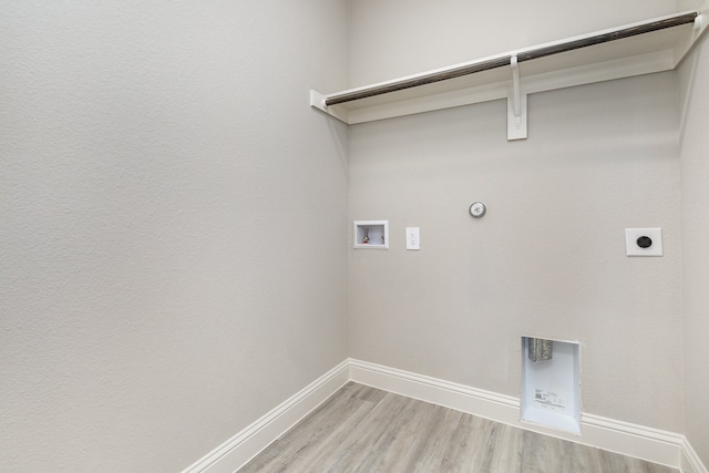 laundry room with hookup for a washing machine, light hardwood / wood-style flooring, electric dryer hookup, and gas dryer hookup