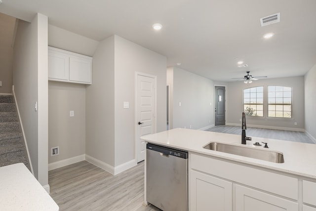 kitchen with sink, dishwasher, white cabinetry, and light wood-type flooring