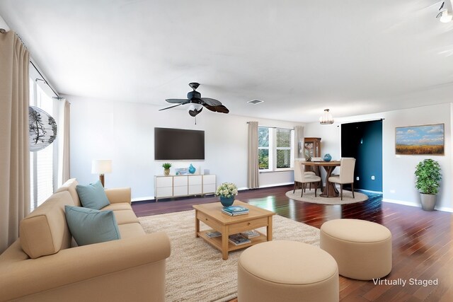 living room with ceiling fan, dark hardwood / wood-style flooring, and a textured ceiling