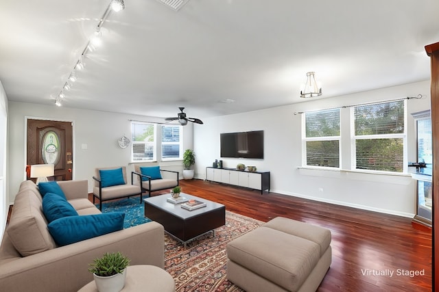 living room with dark wood-type flooring, ceiling fan, and rail lighting