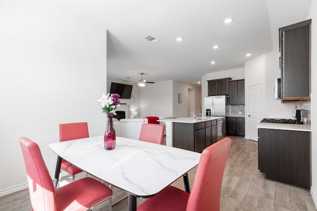 dining space featuring light wood-type flooring and ceiling fan