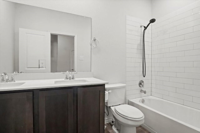 full bathroom with tiled shower / bath, vanity, and toilet