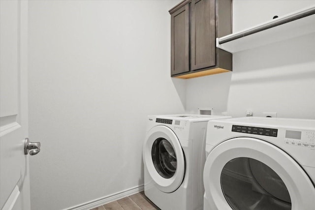 laundry area with cabinets and separate washer and dryer