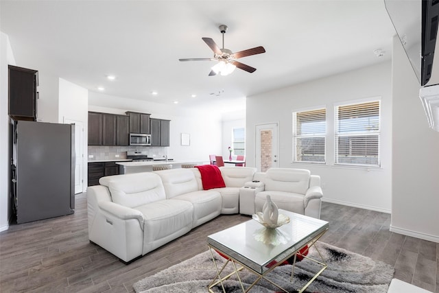 living room with hardwood / wood-style flooring and ceiling fan