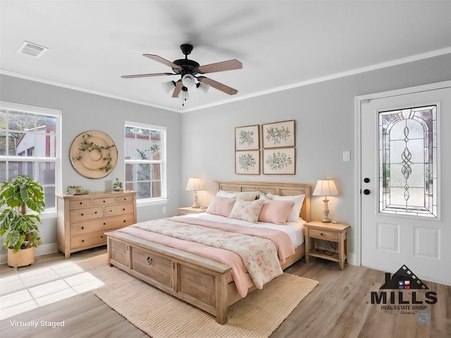 bedroom featuring multiple windows, crown molding, ceiling fan, and light hardwood / wood-style floors