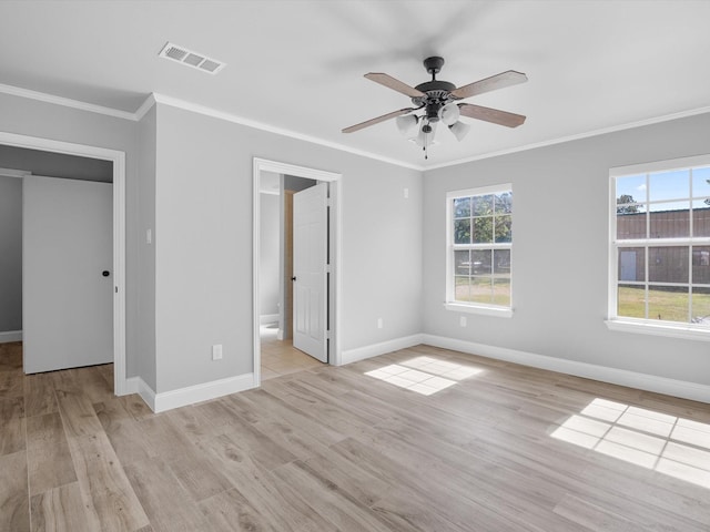 unfurnished bedroom with ceiling fan, ornamental molding, light hardwood / wood-style floors, and ensuite bath