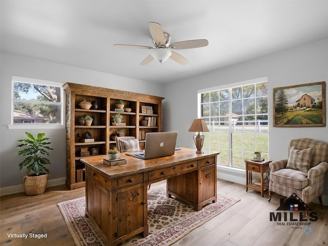 office area with light hardwood / wood-style flooring and ceiling fan