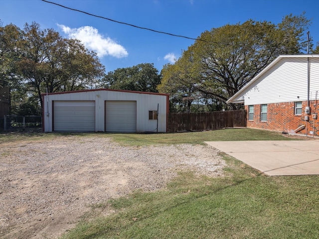 view of yard with a garage and an outdoor structure