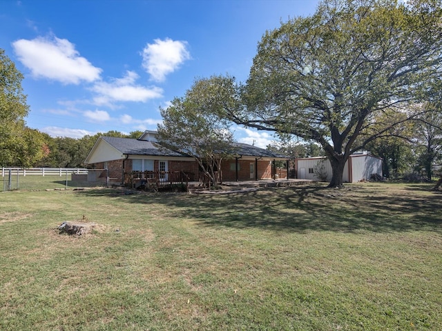 view of yard featuring a storage shed and a deck