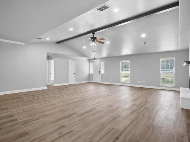 kitchen featuring wall chimney exhaust hood, crown molding, appliances with stainless steel finishes, light stone countertops, and a kitchen island with sink