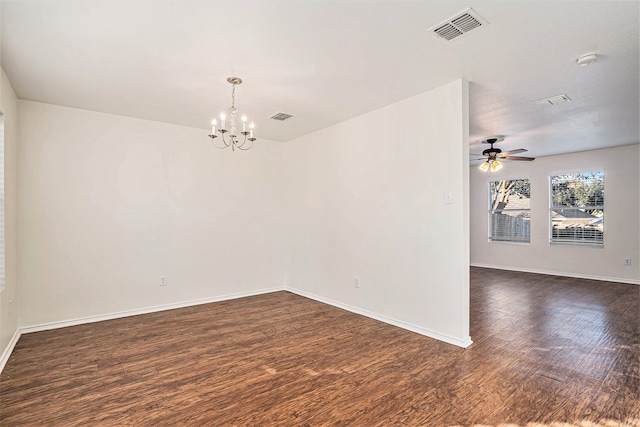 unfurnished room with ceiling fan with notable chandelier and dark hardwood / wood-style flooring