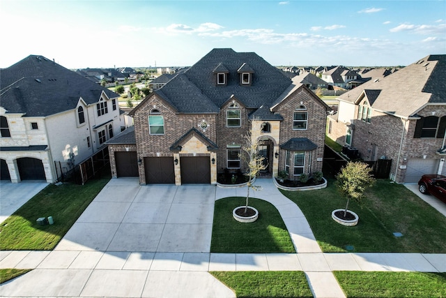 french country inspired facade featuring a garage, a residential view, brick siding, and a front lawn