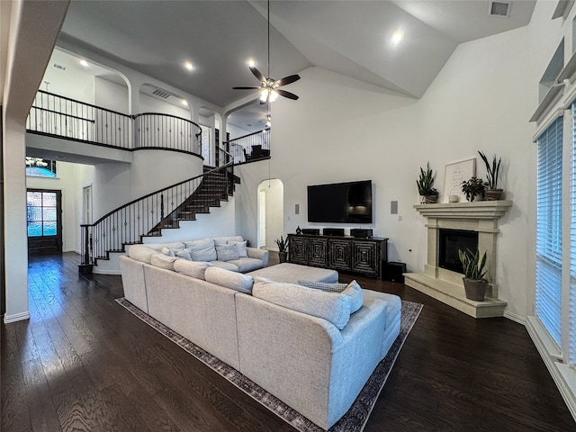 living room featuring a premium fireplace, hardwood / wood-style flooring, high vaulted ceiling, and ceiling fan