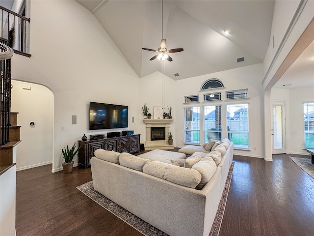 living room featuring ceiling fan, high vaulted ceiling, and dark hardwood / wood-style flooring