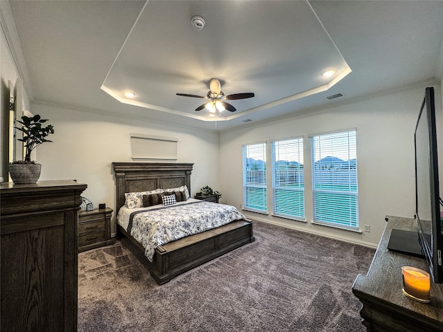 carpeted bedroom with ornamental molding, a raised ceiling, and ceiling fan