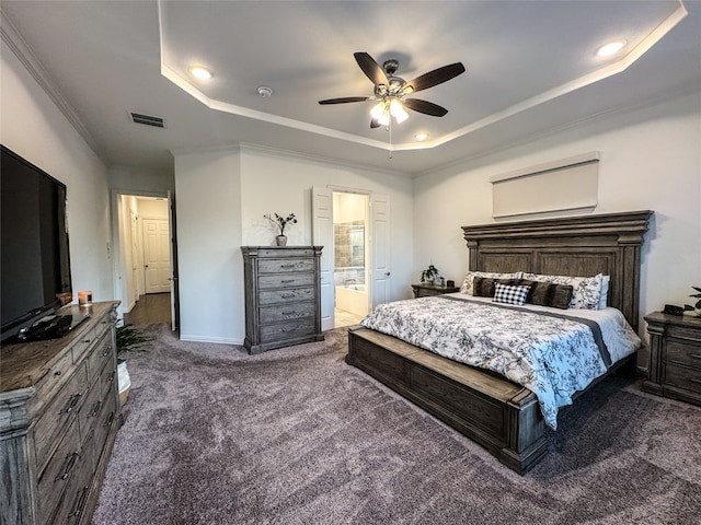 carpeted bedroom featuring connected bathroom, a raised ceiling, ornamental molding, and ceiling fan