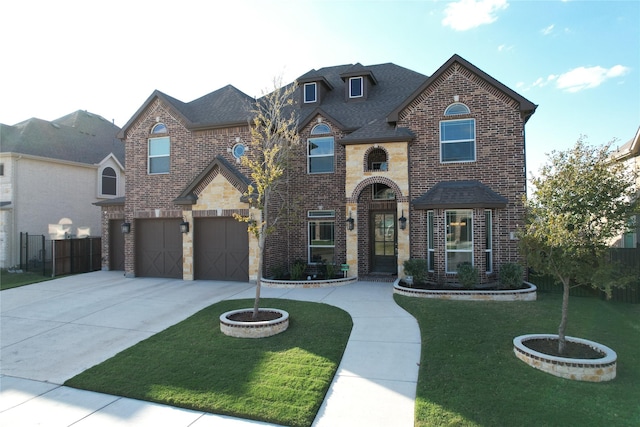 view of front facade featuring concrete driveway, a front yard, brick siding, and stone siding