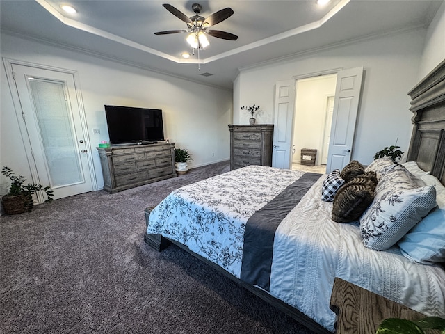 carpeted bedroom with ceiling fan, a raised ceiling, ornamental molding, and a fireplace