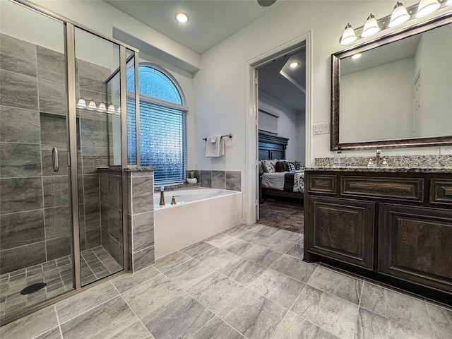 bathroom with vanity and separate shower and tub