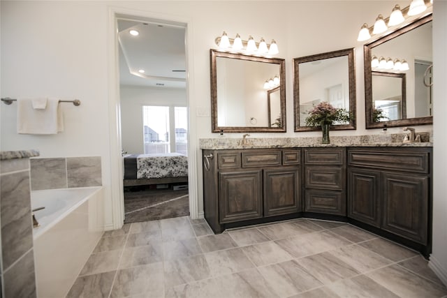 bathroom featuring vanity and a tub to relax in