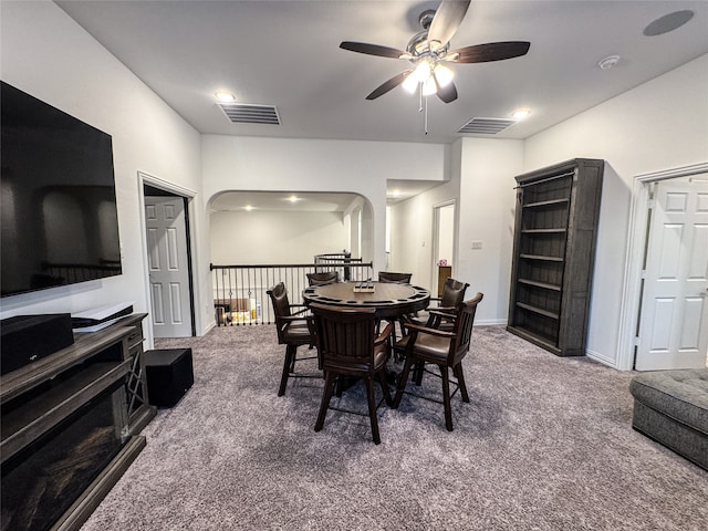 carpeted dining space featuring ceiling fan