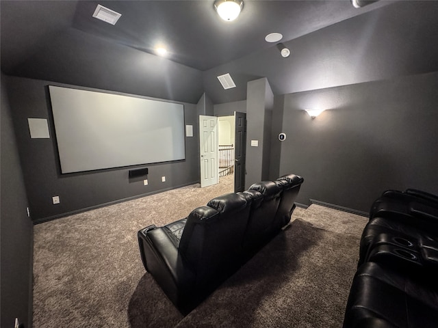 carpeted home theater with vaulted ceiling