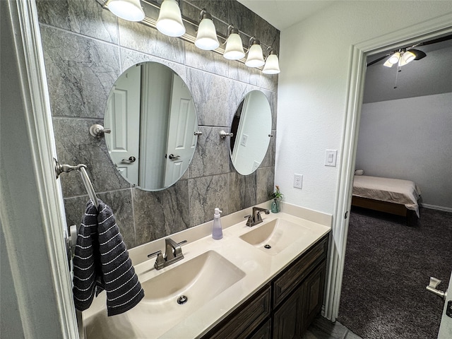 bathroom with tile walls, vanity, and ceiling fan