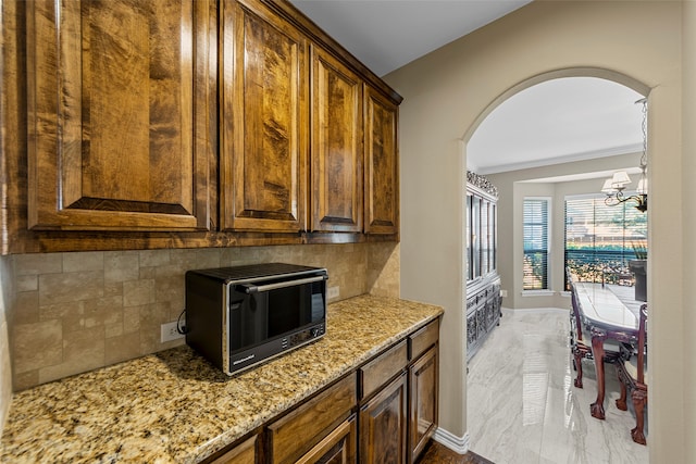 kitchen with an island with sink, dark hardwood / wood-style floors, sink, and black appliances