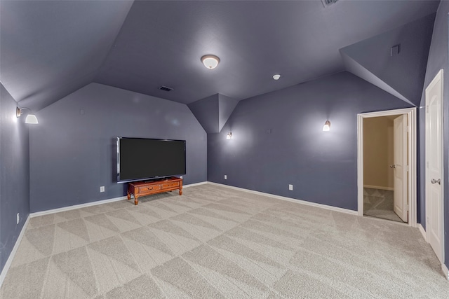 unfurnished living room with ceiling fan, plenty of natural light, light carpet, and lofted ceiling