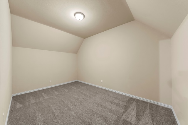 unfurnished living room featuring ceiling fan, light colored carpet, and lofted ceiling