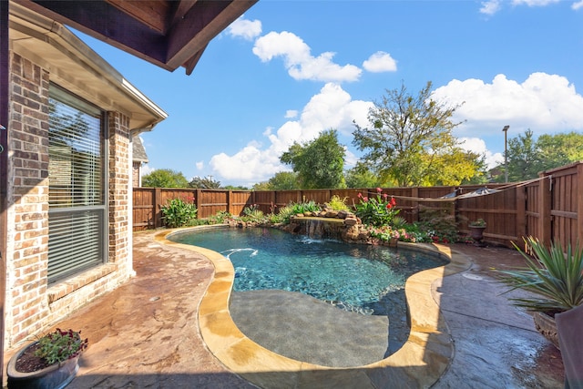 view of pool featuring pool water feature and a patio area