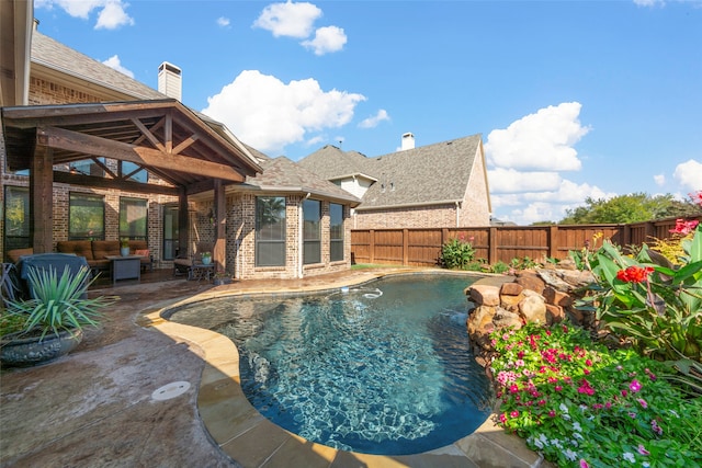 view of pool with a patio area and pool water feature