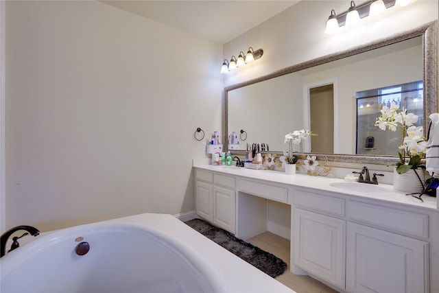 bathroom featuring vanity, a tub, and tile patterned floors