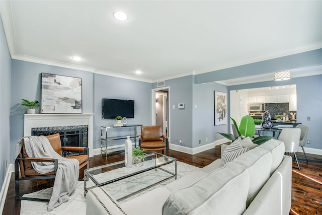 living room featuring hardwood / wood-style floors and crown molding