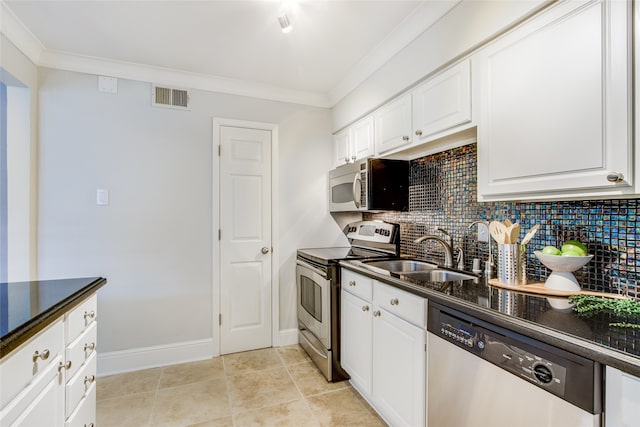 kitchen featuring decorative backsplash, white cabinetry, sink, and appliances with stainless steel finishes