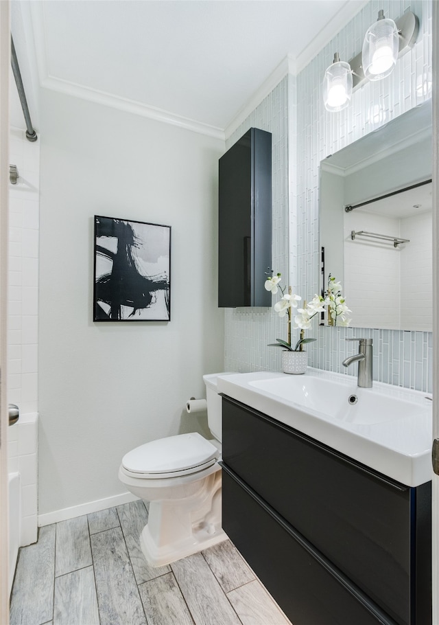 full bathroom featuring plus walk in shower, wood-type flooring, toilet, vanity, and ornamental molding